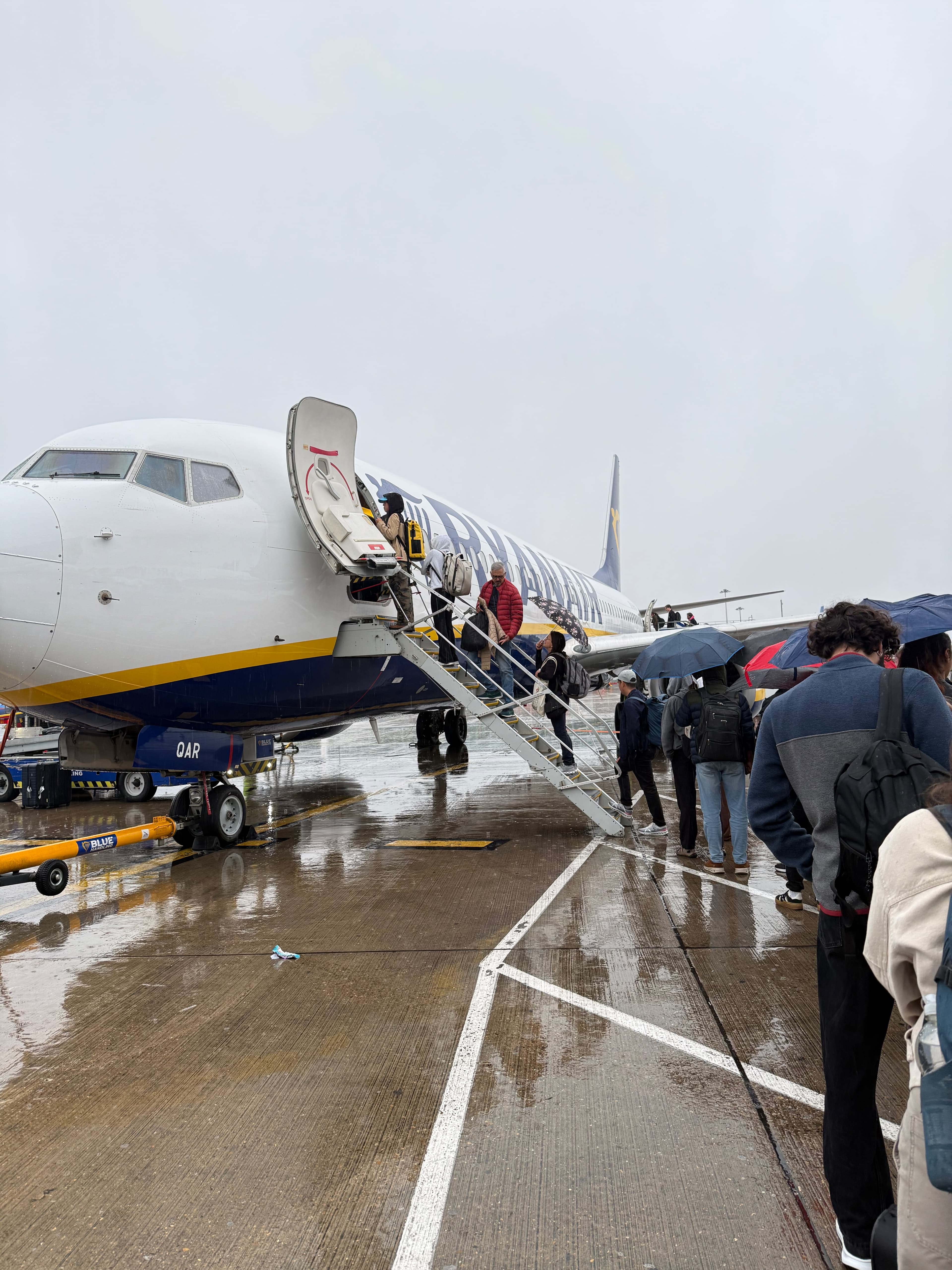 Boarding the early morning Ryanair flight in London under a gloomy, rainy sky.