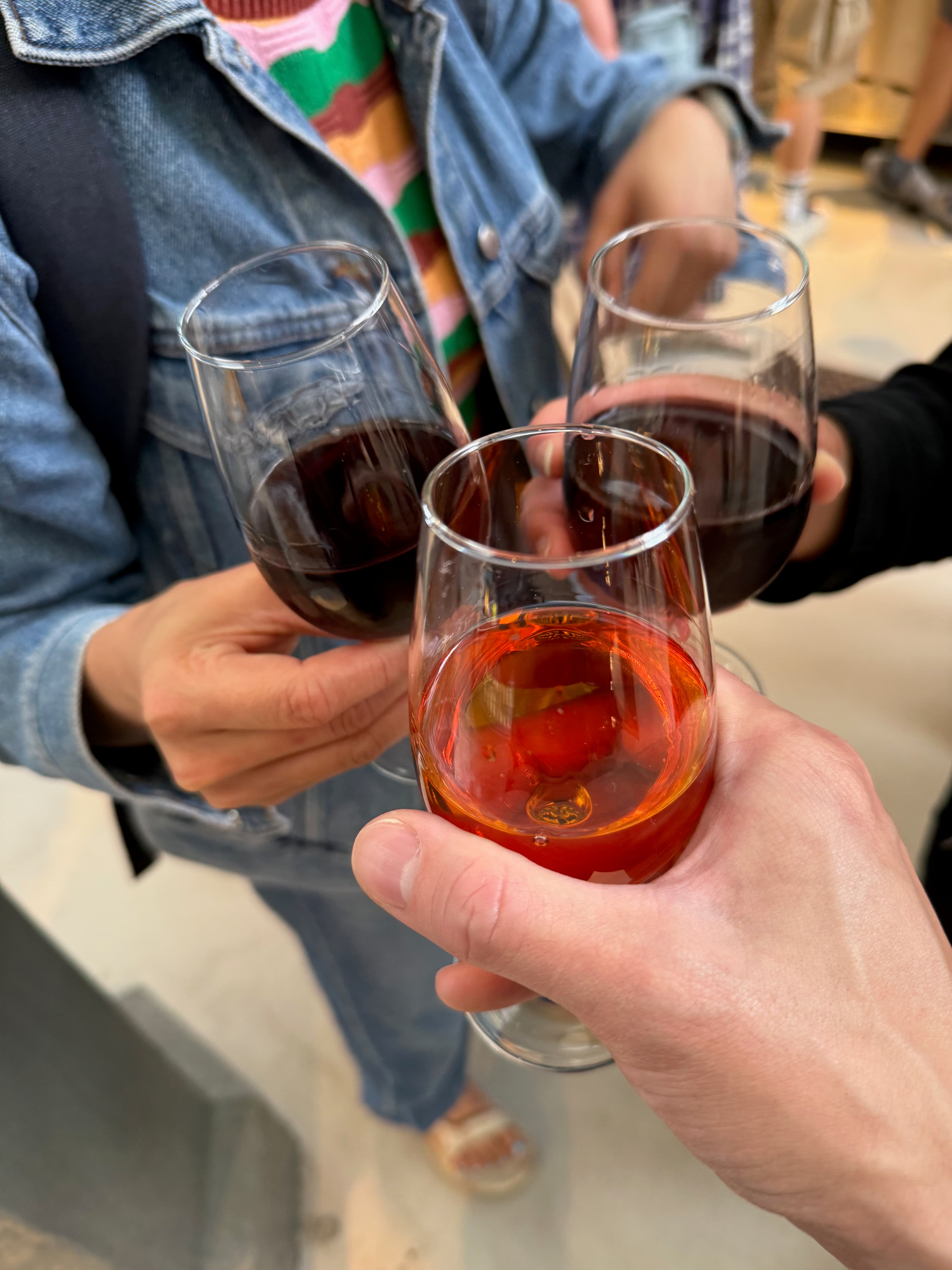 Cheers! Sampling glasses of sweet and smooth local Port wine inside the market stalls.